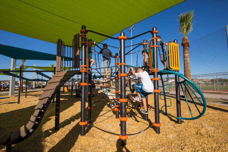kid climbing up the side of equipment