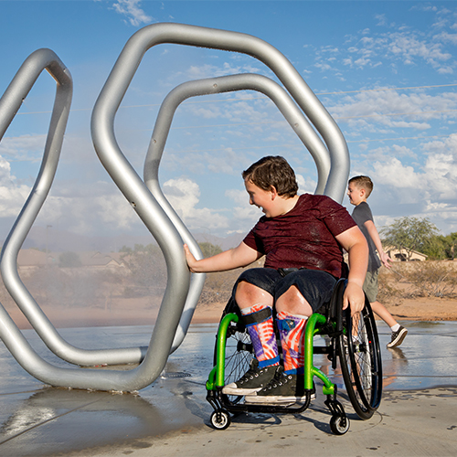 child in wheelchair playing at the park