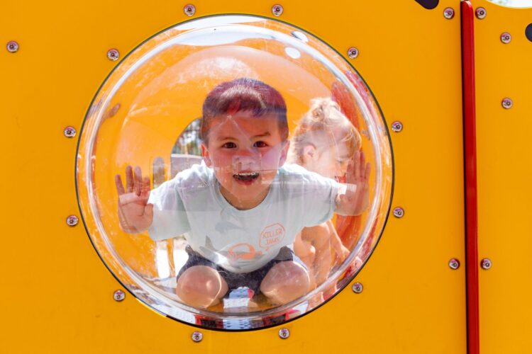 child looking through bubble in playground equipment in Las Vegas, NV