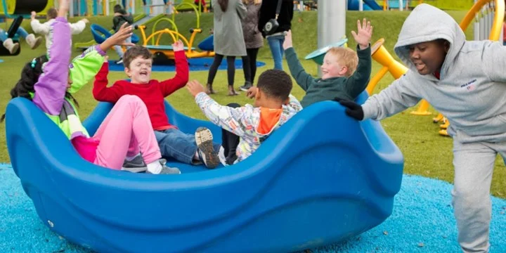 children sitting in inclusive spinning equipment