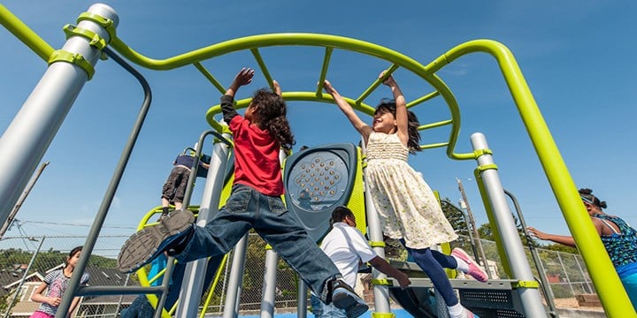 two kids on monkey bars