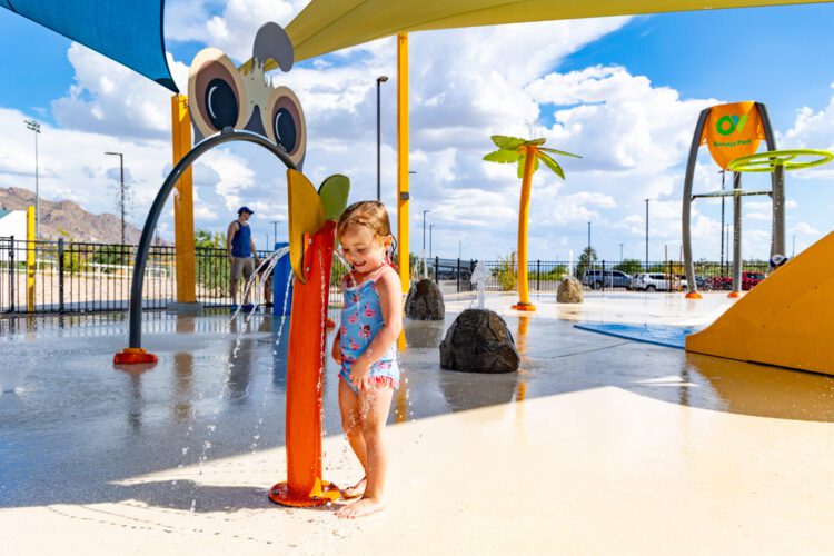 girl playing in water at park