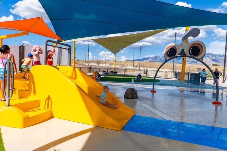 girl going down slide at splashpad