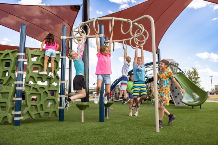 kids climbing across bars