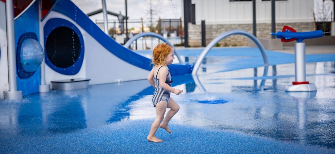 Child playing at a splash pad in Apache Junction, AZ