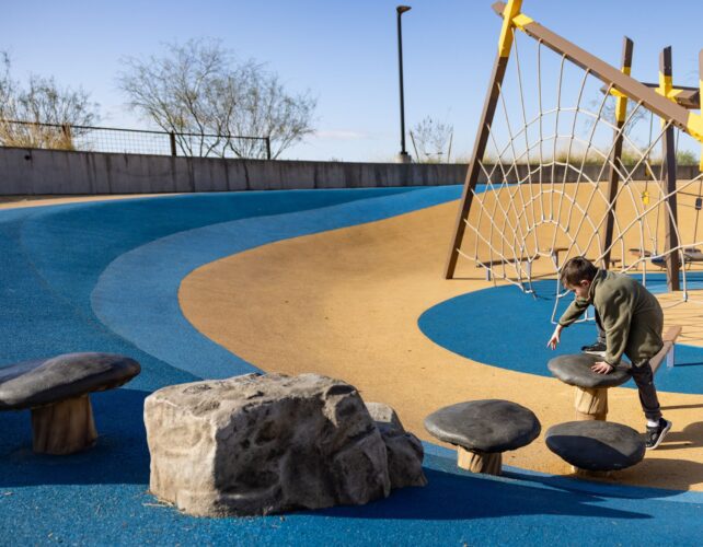Child plays on GFRC play structure with safety surfacing in Apache Junction, AZ