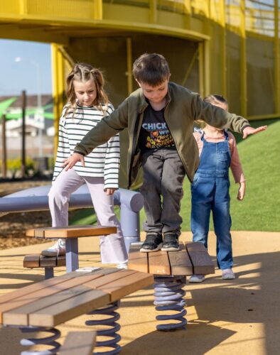 Children playing on playground equipment in Apache Junction, AZ