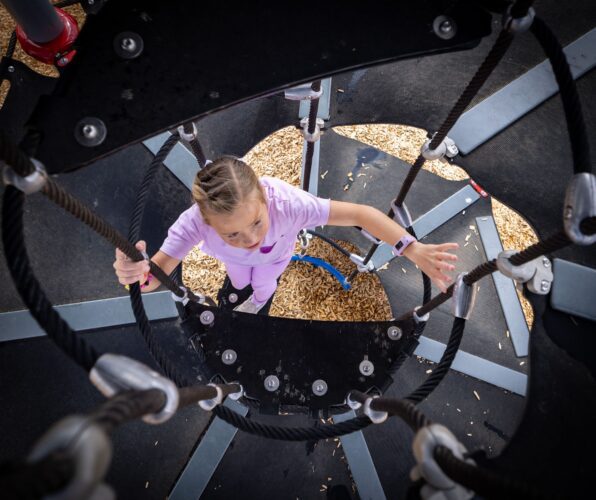 Child climbing into play structure at playground in Apache Junction, AZ