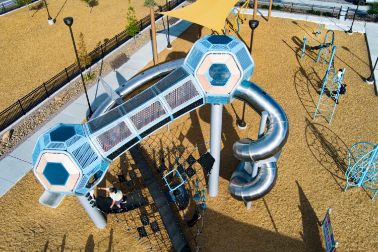 Children play on equipment at Wells Park, Albuquerque, NM
