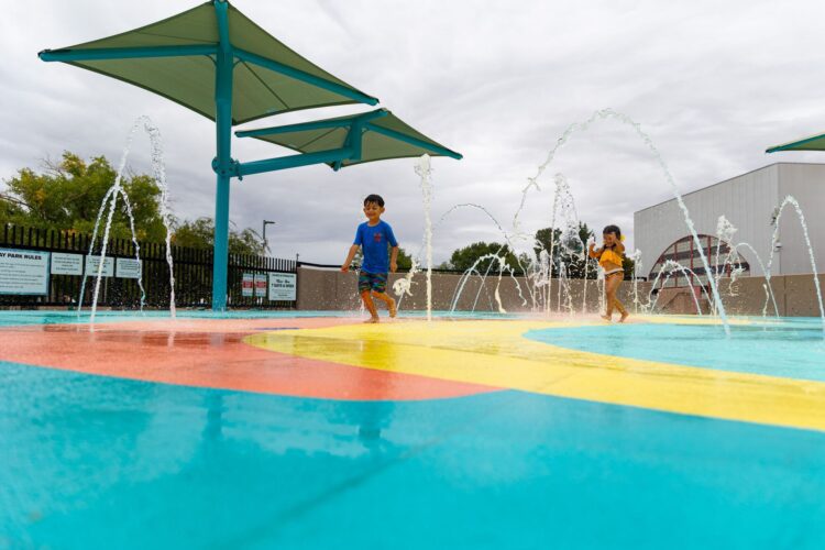 Children playing at outdoor splash pad