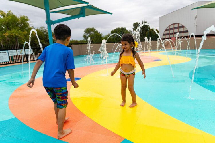 Family-friendly splash pad with kids enjoying water features