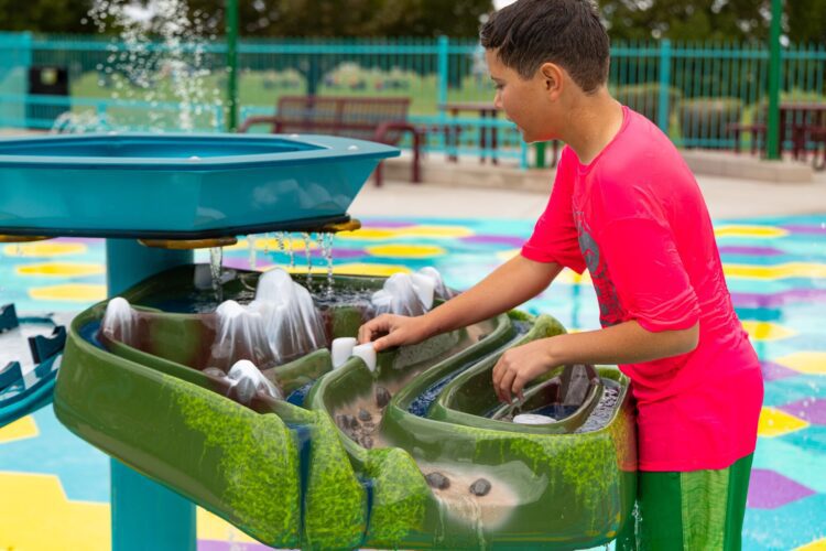 Child plays at splash pad, Manzano Mesa Park, Albuquerque, NM
