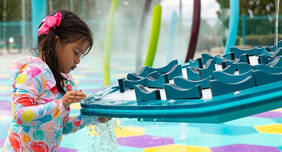Child plays at splash pad, Manzano Mesa Park in Albuquerque, NM