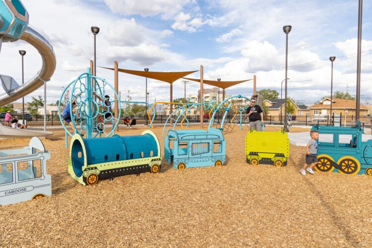 Children play on toy train at Wells Park, Albuquerque, NM