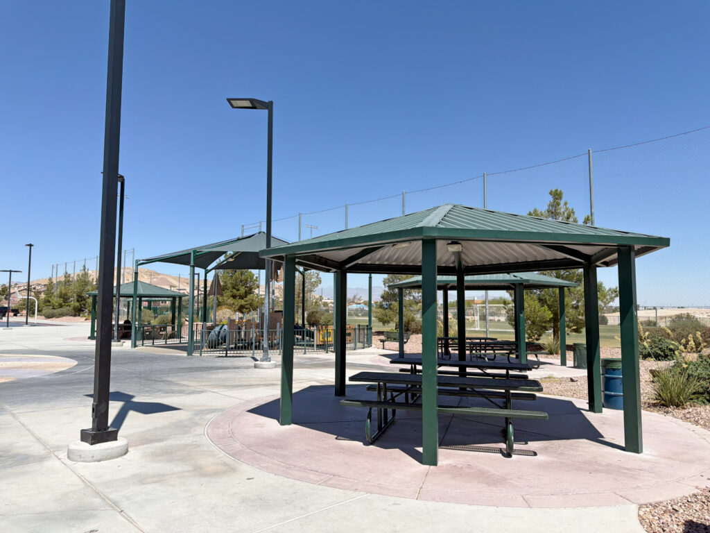 Commercial playground at Olympia Sports Park in Las Vegas, NV with shade, net climbers, slides, and site amenities.