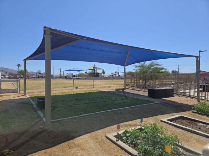 Shade over grass play area at elementary school playground in Lake Havasu, AZ