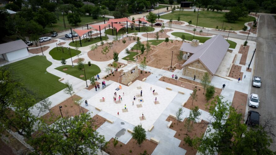 Children play at a splash pad at District 1876, Coleman, Texas.