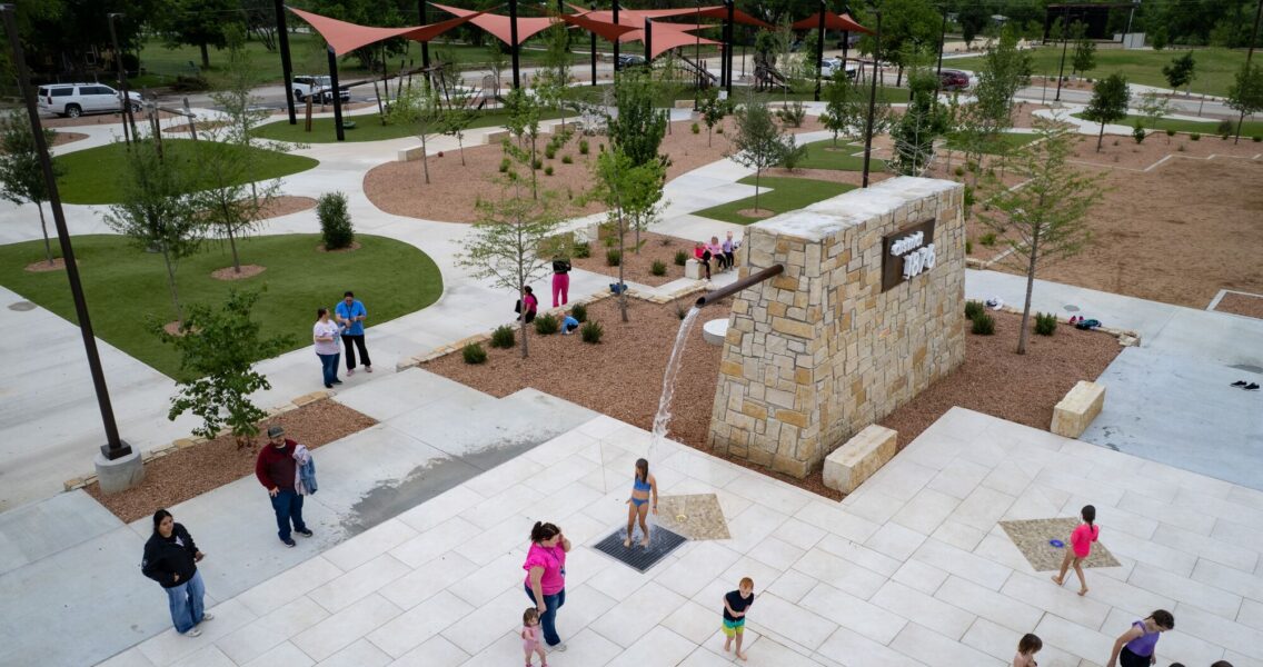 Children play at a splash pad at District 1876, Coleman, Texas.