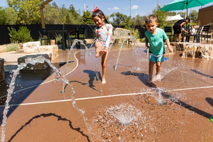 Children having a fun time playing at splash pad at Albuquerque BioPark, in Albuquerque, New Mexico