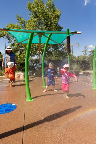 Children play at splash pad at Albuquerque BioPark, in Albuquerque, New Mexico