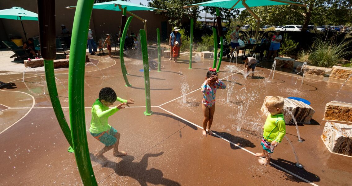 Children laugh and play at splash pad at Albuquerque BioPark, in Albuquerque, New Mexico