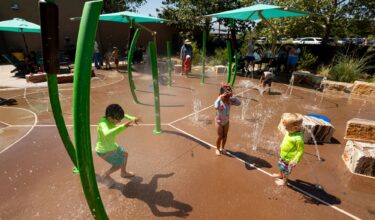 Children laugh and play at splash pad at Albuquerque BioPark, in Albuquerque, New Mexico