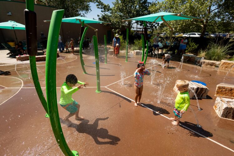 Children laugh and play at splash pad at Albuquerque BioPark, in Albuquerque, New Mexico