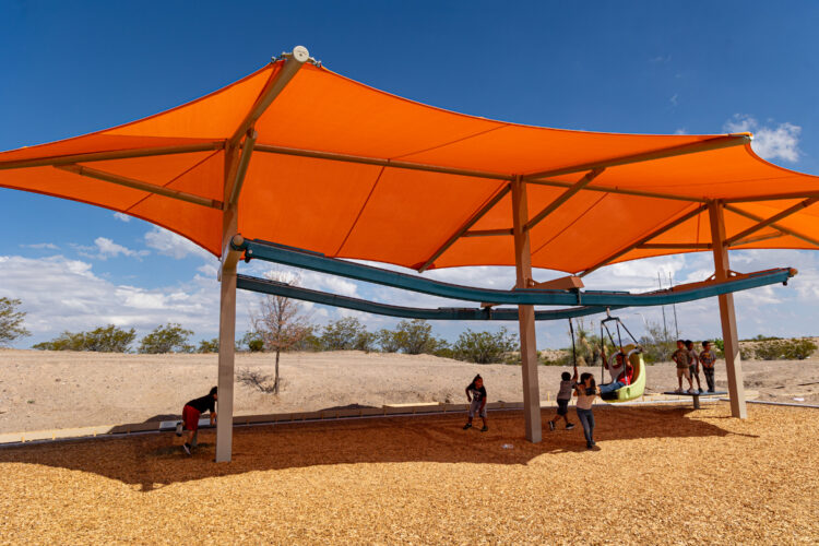 Children zip down a colorful playground zipline at East Mesa Public Recreation Complex, in Las Cruces, New Mexico