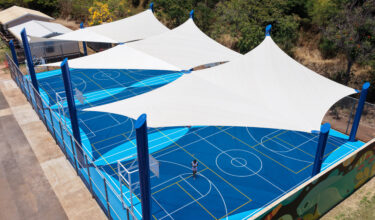 Commercial playground shade structure over sports court at school in Lahaina, Hawaii