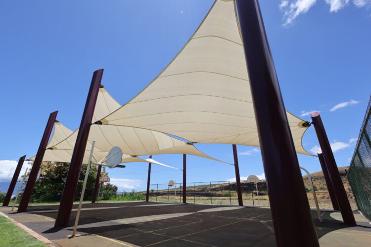 Commercial playground shade structure over sports court at elementary school in Lahaina, Hawaii