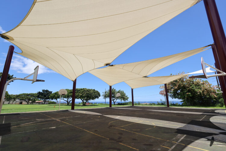 Commercial playground shade structure over sports court at elementary school in Lahaina, Hawaii