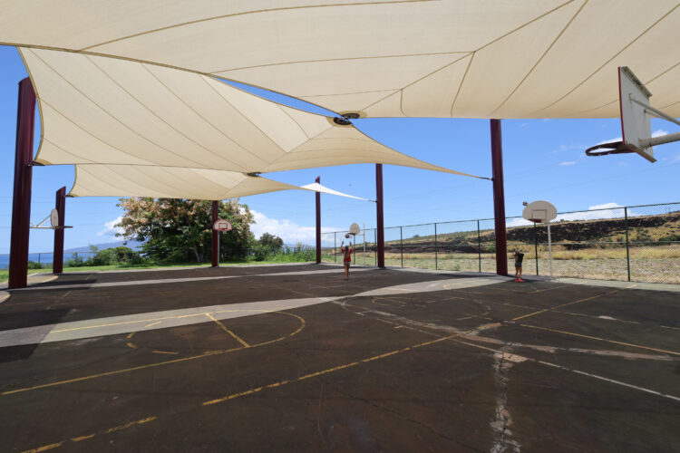 Commercial playground shade structure over sports court at elementary school in Lahaina, Hawaii