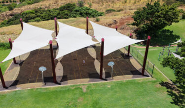 Commercial playground shade structure over sports court at elementary school in Lahaina, Hawaii