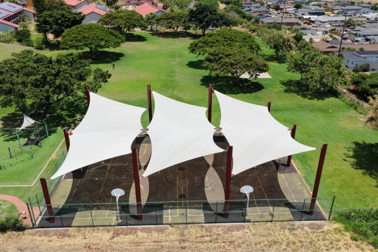Commercial playground shade structure over sports court at elementary school in Lahaina, Hawaii