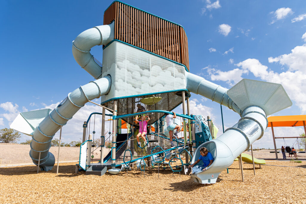 Children play on inclusive play tower, Volo Aire, at East Mesa Public Recreation Complex in Las Cruces, New Mexico