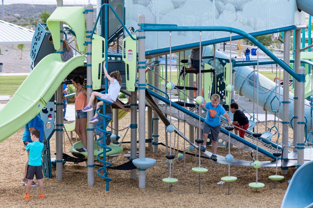 Children play on inclusive play tower, Volo Aire, at East Mesa Public Recreation Complex in Las Cruces, New Mexico